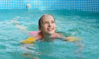 girl-happily-swim-pool-summer (1).jpg